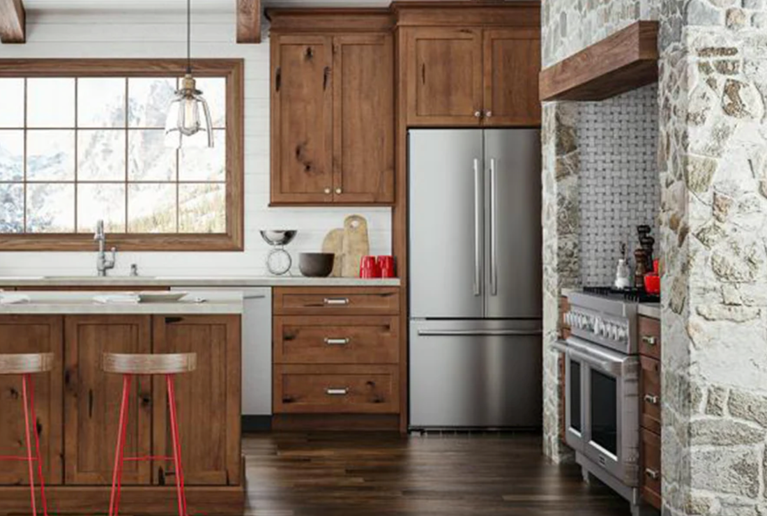 Small modern kitchen with white shaker cabinets, clear counters, and bright natural light.